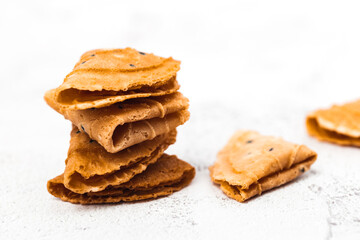 Delicious crispy coconut folded on white background for Thai dessert, asian food and eating concept