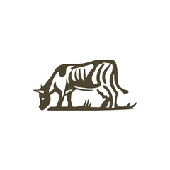 A cow is grazing in a meadow. The cow logo. Cow on a white background
