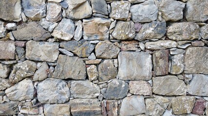 wall made with stones typical of Italy from Liguria to the south to the mountain villages - ancient traditions of hand-made construction by man