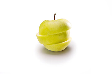 photo of an artistic apple cut into three pieces with white background