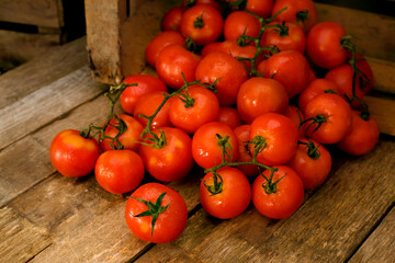 very red tomatoes inside an old wooden basket
