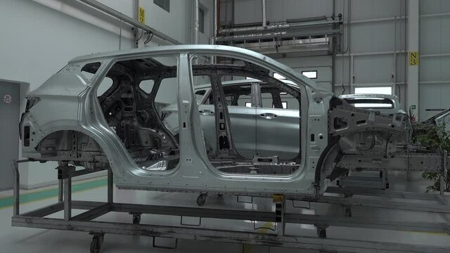 Production line for manufacturing of the car body in the car factory. Car factory. Modern technologies at the plant. Industry concept.