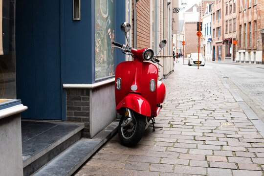 red scooter on a city street