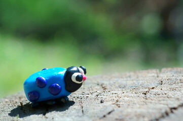 Obraz premium A figurine of a ladybug made of plasticine. Close-up. Summer harvesting.
