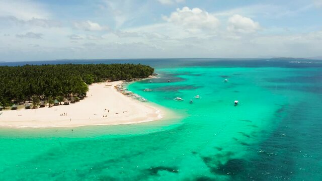 Seascape with beautiful beach and tropical island palm trees by coral reef from above. Daco island, Philippines. Summer and travel vacation concept