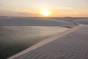 sunset over Lencois Maranhenses national park, Brazil. Dunes and lagoons, paradise tourist destination