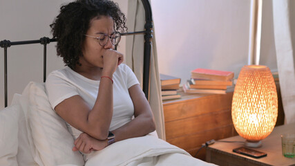 Young African Woman with Cough Sitting in Bed
