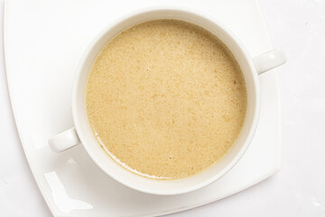 Cremefraiche with pureed parsnips and chopped vegetablesoup cream soup.