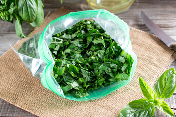 Frozen Herbs (basil) in a plastic bag. Frozen vegetables. Frozen food concept