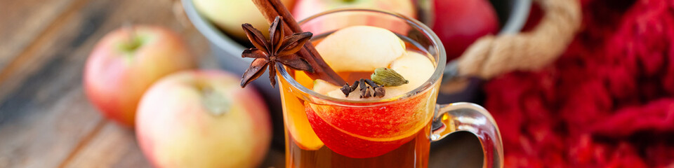 Homemade hot fruit tea with fresh apples, honey, spices: cinnamon, cardamon, anise, clove. Warm...