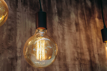 Retro incandescent lamp with warm light. Vintage glowing light bulb.
