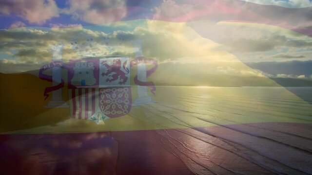 Animation of flag of spain waving over beach landscape and cloudy blue sky
