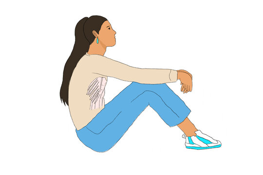 Girl in jeans sitting on ground