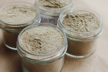 Ayurvedic cosmetic ubtan for face and hair care in glass jars. Vegetable ingredients ground into a powder