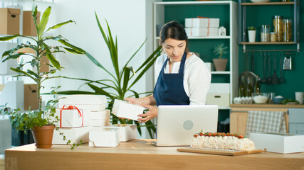 Fototapeta premium Successful Female Small Business Owner Prepares a Customer Order.