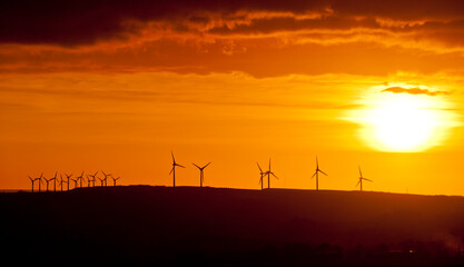 Windfarm during sunset on the skyline