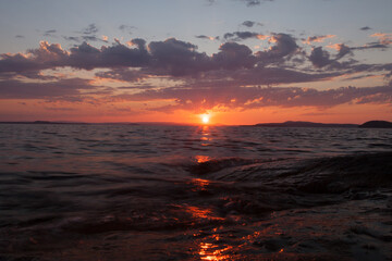 bright orange sunset over the waves scandinavia,