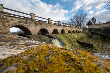 Fototapeta premium Bridge and river Rokytka in Dolni Pocernice, Prague, Czech republic