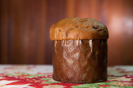Panettone on the table with a Christmas tablecloth. Panettone concept. Christmas concept. copy space.
