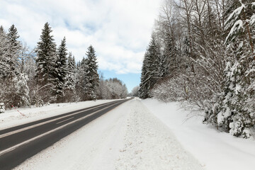 a road covered with snow in the winter season