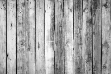 Naklejka premium Wooden texture background. Black and white beautiful old wooden wall or fence close up. Grey backdrop for design. Vertical wooden boards. Close up, copy space