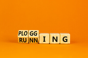 Running or plogging symbol. Turned wooden cubes and changed the word running to plogging. Beautiful orange table, orange background, copy space. Sports, ecological, running or plogging concept.