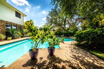 Backyard oasis with a swimming pool inside a private residential backyard - 453364509