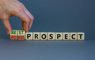 Best or worst prospect symbol. Businessman turns wooden cubes and changes words 'worst prospect' to 'best prospect'. Beautiful grey background. Business, best or worst prospect concept. Copy space.