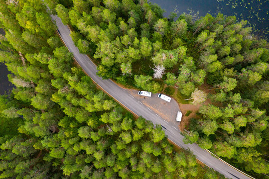 Aerial view of campers parked next to a forest road by a lake in Punkaharju, Finland