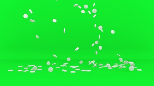 White aspirin pills or tablets falling and stacking on green screen. Medicine concept. Use it for headache, medical care, antibiotics.