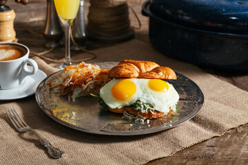 croissant egg sandwich hash brown juice