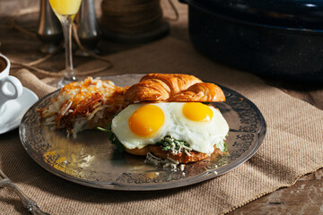 croissant egg sandwich hash brown juice