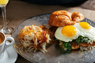 croissant egg sandwich hash brown juice