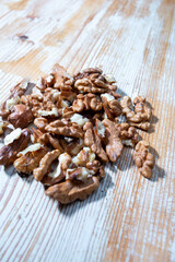crashed walnuts on wooden background