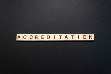 Word Accreditation made up of wooden blocks on black background. Minimum concept, copy space