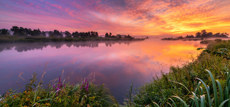 Colorful sunrise over the river banks