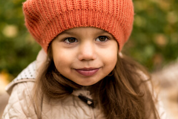 Close Up Portrait Of Little Cute Preschool Minor Girl In Orange Beret On Yellow Fallen Leaves Nice Smiling Looking At Camera In Cold Weather In Fall Park. Childhood, Family, Motherhood, Autumn Concept