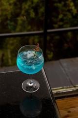 Blue cocktail on top of black table