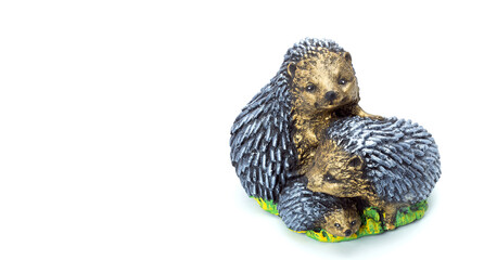 Fototapeta na wymiar artificial family of hedgehogs concrete garden figure for landscaping and backyard decoration, isolated stone object on white background, nobody.