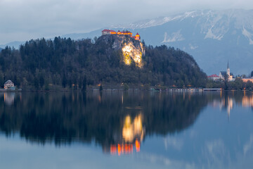Lake Bled in the middle of the island with the church and the castle at sunset in the Triglav...