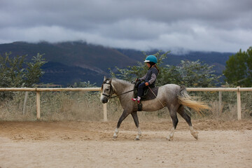 5-year-old girl riding a horse. infalltil sport concept