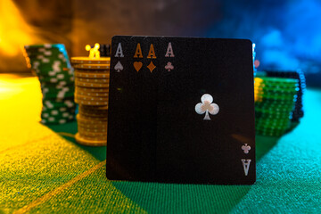 Poker cards, chips on the green cloth of the poker table. Interesting lighting. Concept - gambling, poker, sports, gambling business. There are no people in the photo.
