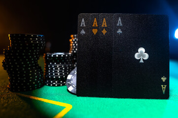 A strong position in four of a kind is four aces. Poker cards, chips on the green cloth of the poker table. Minimalism, strict lines. Casino, night club, poker club, advertising.