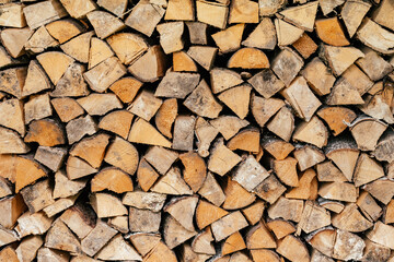 Texture background image of chopped firewood stacked in a woodpile, copy space