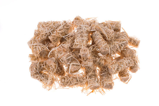 Rolls of organic eco friendly natural wooden firelighters for barbeque, firestarter rolls isolated over white background.