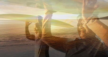 Composite of happy senior couple walking carrying surfboards on heads, and beach at sunset