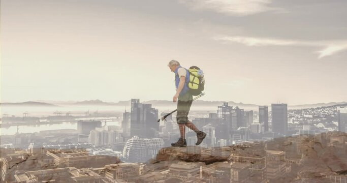 Composite of caucasian senior man hiking on mountain, and modern cityscape