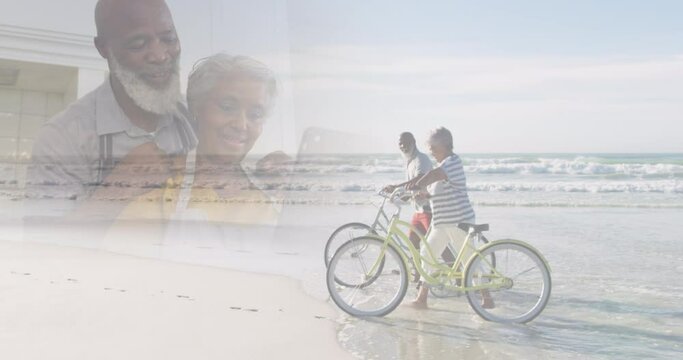 Composite of happy diverse senior using laptop at home, and on bikes at beach
