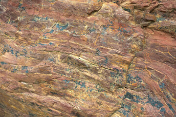 Granite texture. Red stone in detail. Natural background chipping rocks.