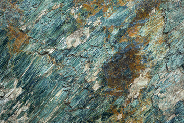 Green stone texture. The surface of the rock. Rock in detail.